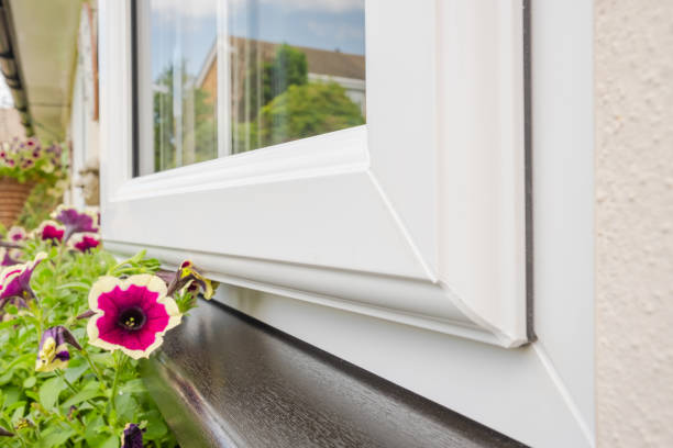 A pretty flowering window basket is seen below the black window seal.